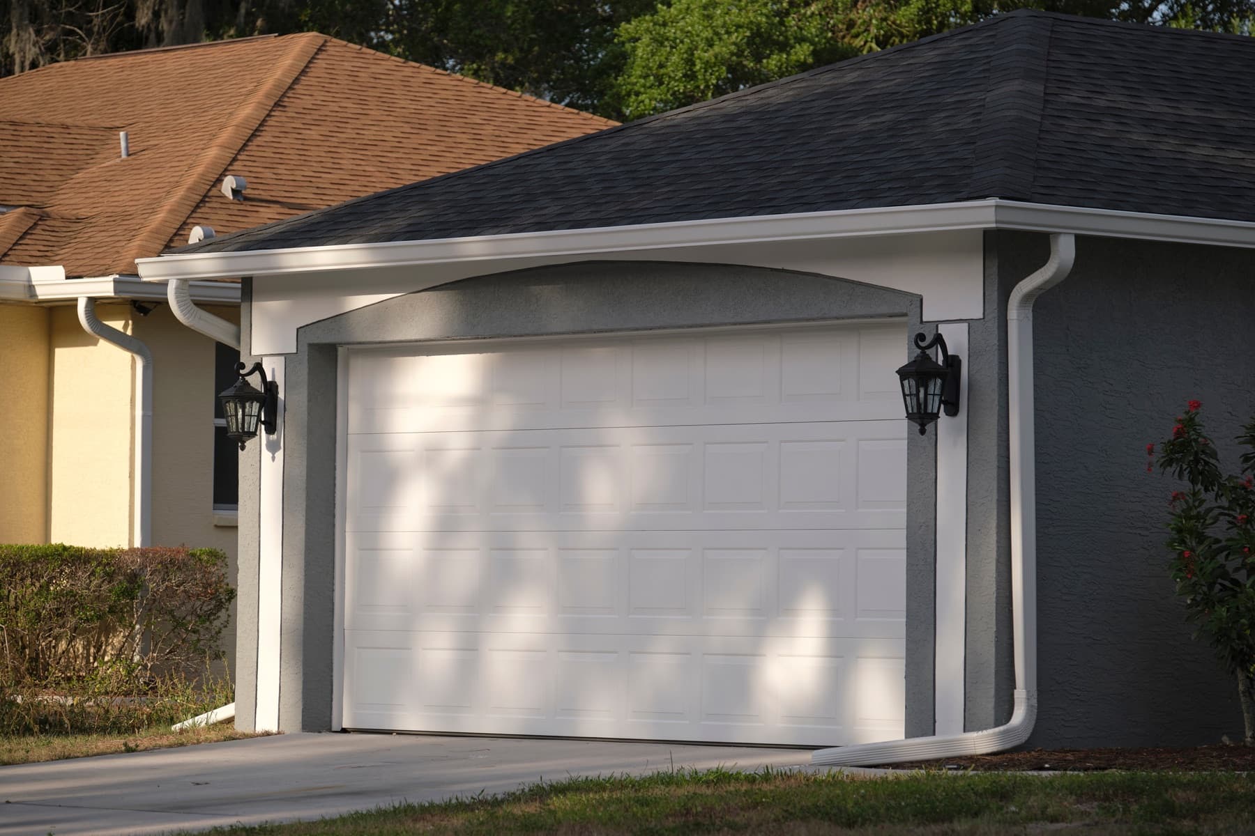 White sectional garage door on a gray house